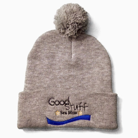 Grey beanie with a puff on top featuring heavy embroidery showcasing Good Stuff Health Sea Moss Gel.