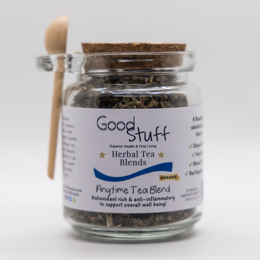 Glass jar including a wooden spoon full of an anytime herbal blend made from Red Raspbery Leaf, Holy Basil, Stinging Nettle, and Blessed thistle. All alkaline, organic, electric, and vegan.