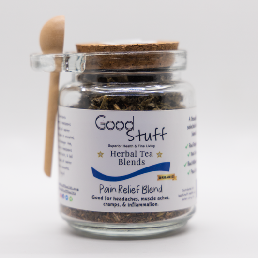 Glass jar including a wooden spoon full of a pain relief herbal blend made from Red Raspberry Leaf, Pau d'arco, Red Willow Bark, and Red Clover. All alkaline, organic, electric, and vegan.